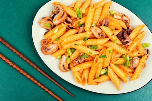 Delicious macaroni or pasta with octopus. Macaroni with seafood. American appetizer.