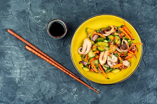 Salad of cucumber, onion and octopus. Korean food. Korean cuisine with seafood. Copy space.