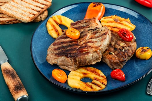 Yummy grilled meat,roasted with pineapple. Grilled steak and ananas, bbq. Top view.