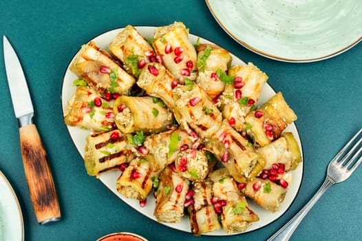 Georgian eggplant rolls with walnut and meat filling, badrijani. Top view.