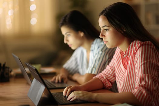 Tele workers working online in the night at home