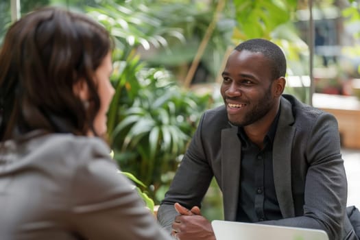 A man and a woman engrossed in discussion at a table, animatedly sharing thoughts and ideas.