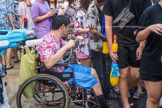 Siam Square, Bangkok, Thailand - APR 13, 2024 Songkran Festival, The short action of people joins celebrations of the Thai New Year or Songkran in Siam Square Bangkok, Thailand.