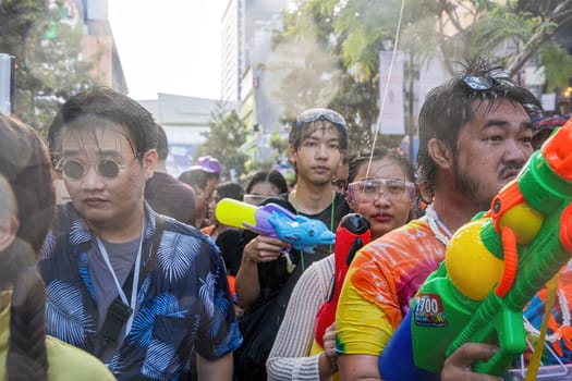 Siam Square, Bangkok, Thailand - APR 13, 2024 Songkran Festival, The short action of people joins celebrations of the Thai New Year or Songkran in Siam Square Bangkok, Thailand.