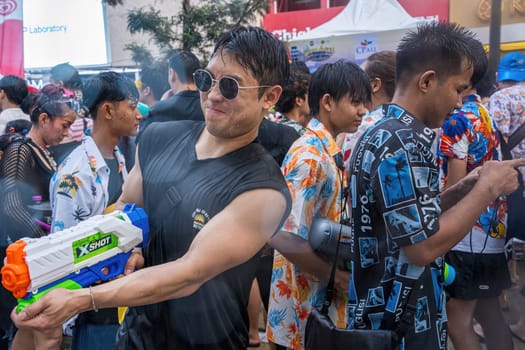 Siam Square, Bangkok, Thailand - APR 13, 2024 Songkran Festival, The short action of people joins celebrations of the Thai New Year or Songkran in Siam Square Bangkok, Thailand.