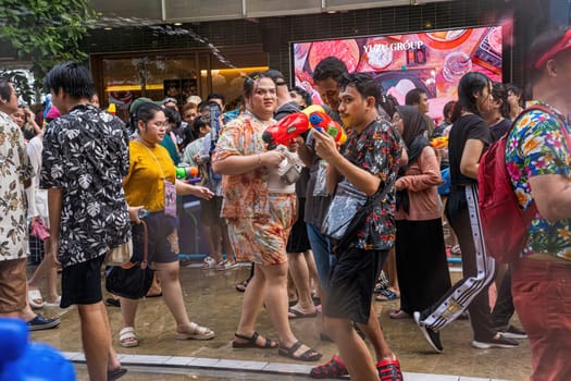 Siam Square, Bangkok, Thailand - APR 13, 2024 Songkran Festival, The short action of people joins celebrations of the Thai New Year or Songkran in Siam Square Bangkok, Thailand.