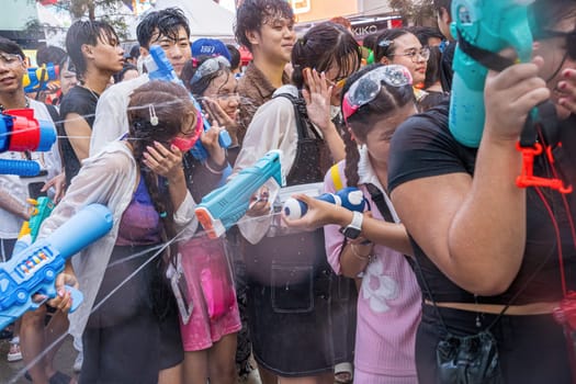 Siam Square, Bangkok, Thailand - APR 13, 2024 Songkran Festival, The short action of people joins celebrations of the Thai New Year or Songkran in Siam Square Bangkok, Thailand.