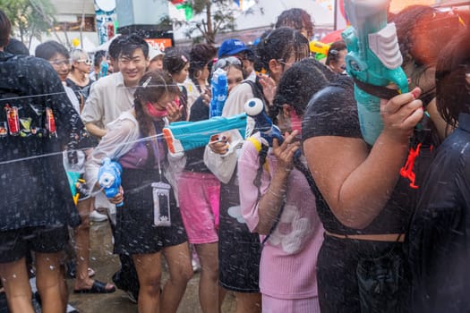 Siam Square, Bangkok, Thailand - APR 13, 2024 Songkran Festival, The short action of people joins celebrations of the Thai New Year or Songkran in Siam Square Bangkok, Thailand.