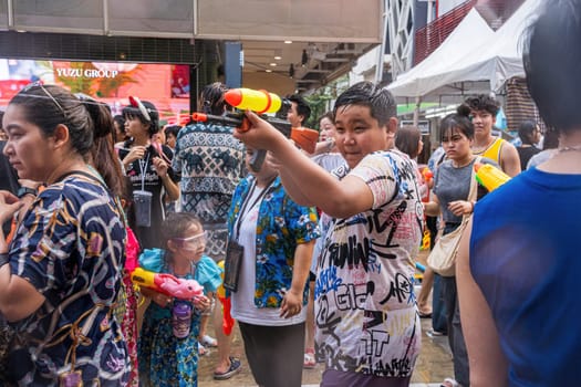 Siam Square, Bangkok, Thailand - APR 13, 2024 Songkran Festival, The short action of people joins celebrations of the Thai New Year or Songkran in Siam Square Bangkok, Thailand.