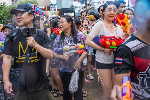 Siam Square, Bangkok, Thailand - APR 13, 2024 Songkran Festival, The short action of people joins celebrations of the Thai New Year or Songkran in Siam Square Bangkok, Thailand.