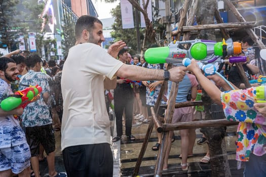 Siam Square, Bangkok, Thailand - APR 13, 2024 Songkran Festival, The short action of people joins celebrations of the Thai New Year or Songkran in Siam Square Bangkok, Thailand.
