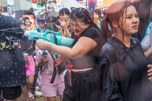 Siam Square, Bangkok, Thailand - APR 13, 2024 Songkran Festival, The short action of people joins celebrations of the Thai New Year or Songkran in Siam Square Bangkok, Thailand.