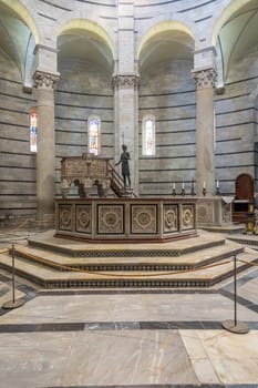 Pisa, Italy - 29 June 2023: Baptistery interior, basilica altar, catholic church. Italy travel destination.