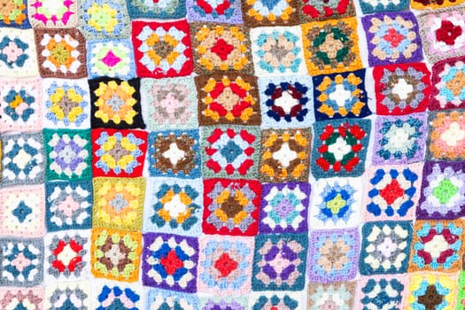 Multi colored blanket in wool, geometric background, retro decorative pattern