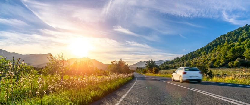 rental car in spain mountain landscape road at sunset