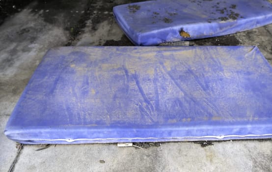 Detail of mattresses thrown in the trash, pollution