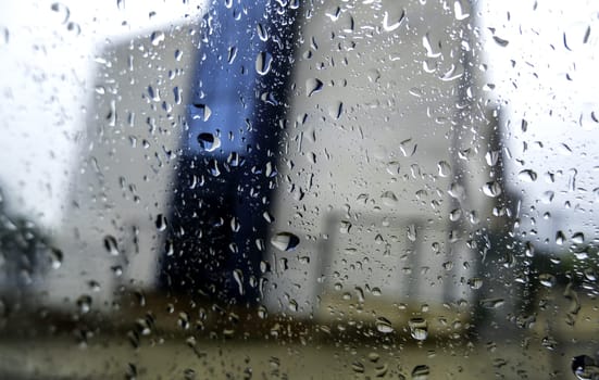 Detail of wet car window on cold winter rainy day