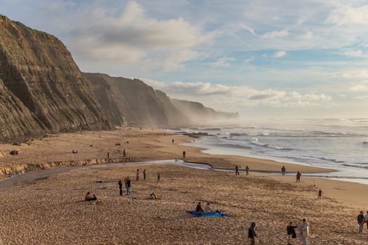 Sintra, Portugal: February 17, 2024: People at the beach of Magoito in a winter day, Sintra, Portugal