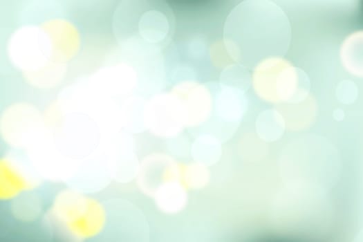 Abstract gradient light blue turquoise yellow green shiny blurred background texture with circular bokeh lights. Beautiful fresh backdrop. Space for design.