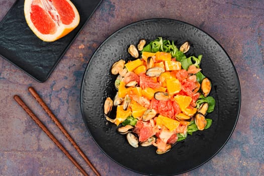 Exotic seafood Mediterranean salad with grapefruit, orange and mussels.