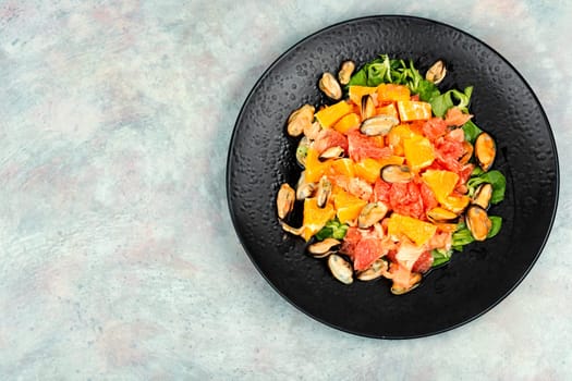 Seafood salad with grapefruit, orange and mussels. Top view, copy space.
