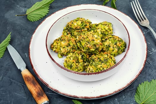 Baked green dietary cutlets made from young nettles. Vegetarian food. Space for text.