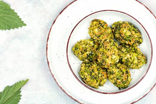 Baked green dietary cutlets made from young nettles. Vegetarian food. Space for text.