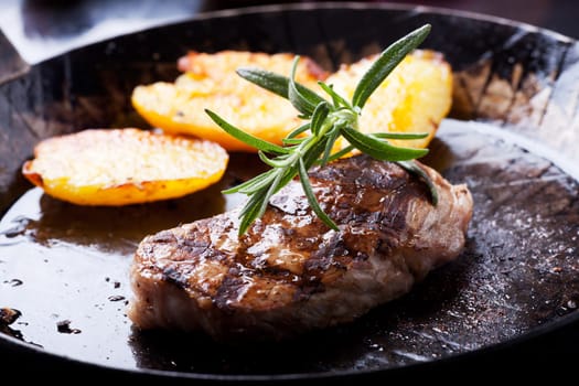 closeup of a rosemary leaf on a steak
