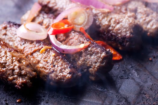 cevapcici minced meat rolls in a pan