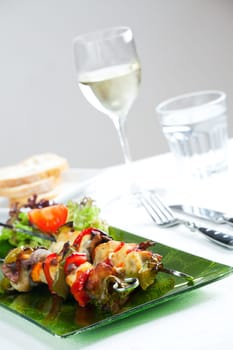 chicken meat on skewers and salad