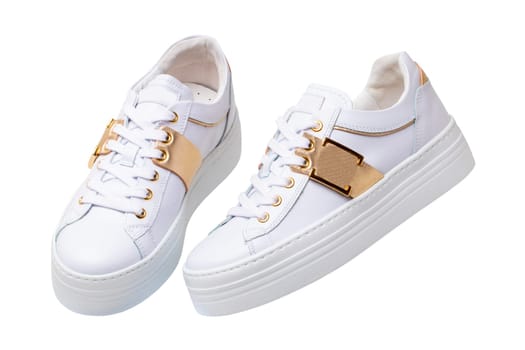 White sneaker isolated. Close-up of a pair white elegant stylish female leather high-heeled sport shoes isolated. Womens shoe fashion. Modern footwear for workout.