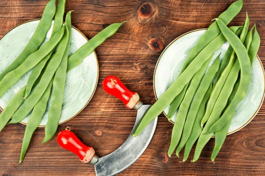 Raw runner beans, organic green beans on a rustic wooden table