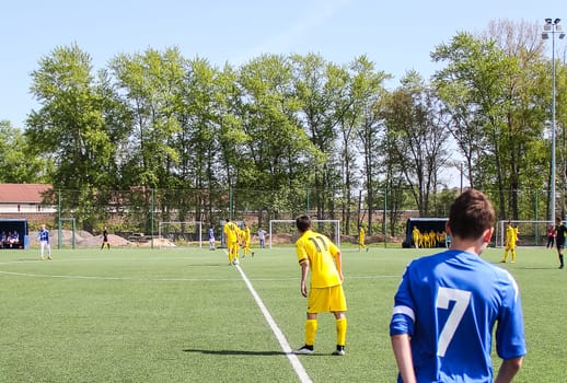 Russia, Volgodonsk - may 17, 2015: Football game. Training matches junior teams and fans