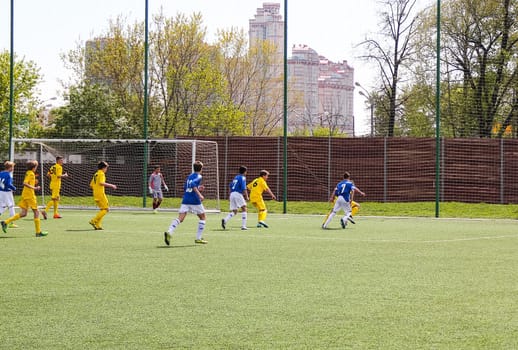Russia, Volgodonsk - may 17, 2015: Football game. Training matches junior teams and fans