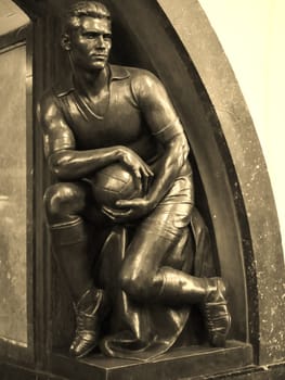Statue of volleyball. Monument athletes volleyball players from bronze.