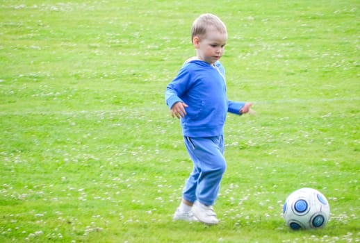 Russia, Volgodonsk - may 17, 2015: A child and a soccer ball. The kid wants to be a footballer.