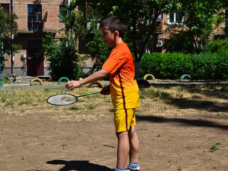 A child playing badminton. Yard games children.