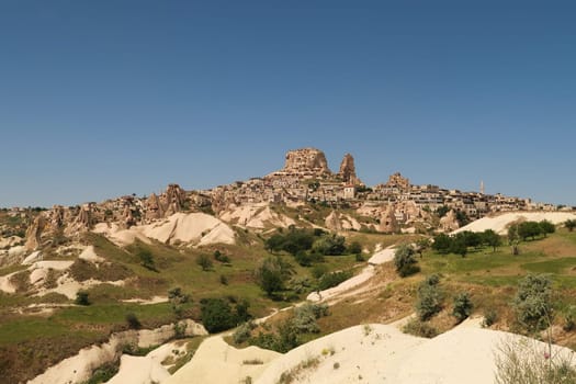 First view of Uchisar coming from Göreme through the Pigeon Valley, Güvercinlik Vadisi, Cappadocia, Turkey 2022