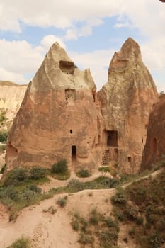 View onto the two fairy chimneys that house the Cross, Crusader Church, Hacli Kilise in the Red Valley, Kizilcukur Vadisi close to Göreme, Cavusin, Cappadocia, Turkey 2022