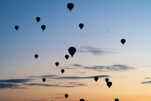 Many hot air balloons rising over the landscape of the Red Valley, Rose Valley, close to Goreme, Cavusin, Cappadocia, Turkey 2022
