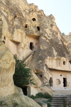 Several rock cut structures on a cliff at the Göreme Open Air Museum, the Maltese Cross Church, Malta Hacli Kilise at the top and larder, refectory and kitchen spaces at the bottom, Göreme, Cappadocia, Turkey 2022