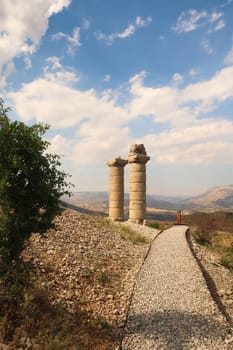 Footpath and two of the columns at the Karakus Tumulus, memorial grave of the Commagene Royal Family, close to Adiyaman, Turkey 2022
