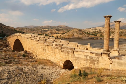 View from above onto the beautiful Severan, Cendere Bridge, a column on the left, close to Adiyaman, Turkey 2022