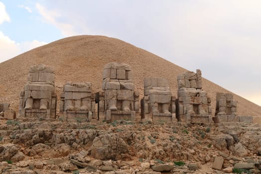 The majestic stone statues, sculptures on the East Terrace of Mount Nemrut, headless bodies of Antiochus, the Goddess of Commagene, Zeus, Apollon and Heracles sitting on thrones, close to Adiyaman, Turkey 2022
