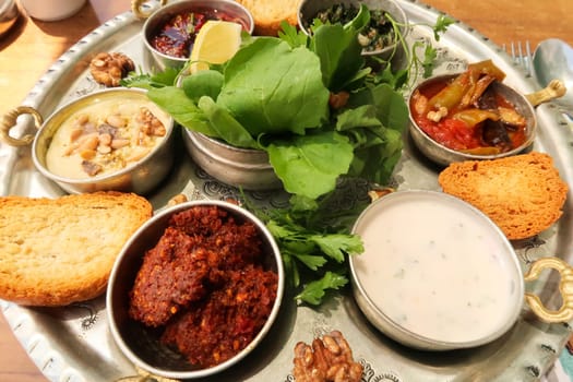 Big mezze, meze platter with served in a traditional restaurant in the old town of Mardin, Turkey 2022