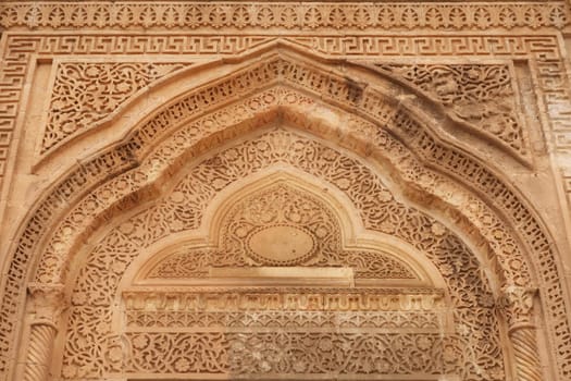 Elaborate carved patterns and details on top of the doorway of a traditional house in the old town of Mardin, Turkey 2022