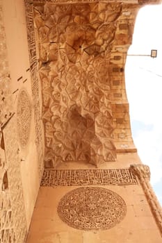Elaborate carved patterns and details on the majestic gate of the Sultan Isa Medrese, Madrasa, Zinciriye Medrese in the old town of Mardin, Turkey 2022