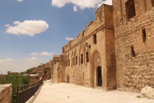 A row of traditional houses on a hill overlooking the old town of Mardin, Turkey 2022