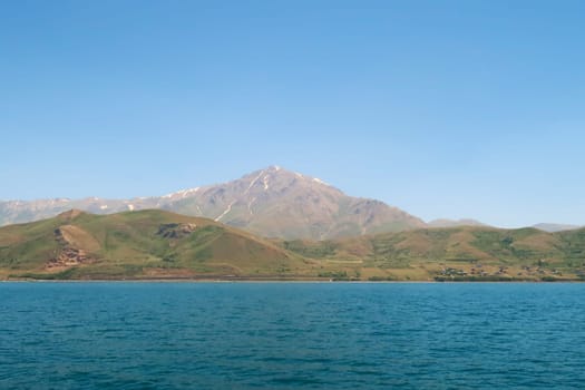 Mount Artos seen from Lake Van, Van Gölü, the intense blue color of the water in the foreground and the dormant volcano in the background, Van, Turkey 2022