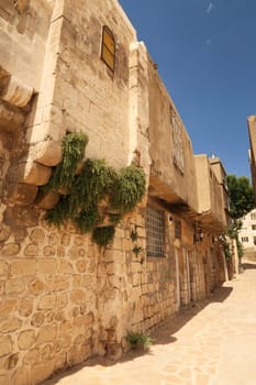 A row of traditional houses next to a small alleyway in the old town of Mardin, Turkey 2022